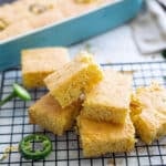 Sliced jalepano cheddar cornbread on a cooling rack.