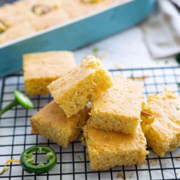 Sliced jalepano cheddar cornbread on a cooling rack.