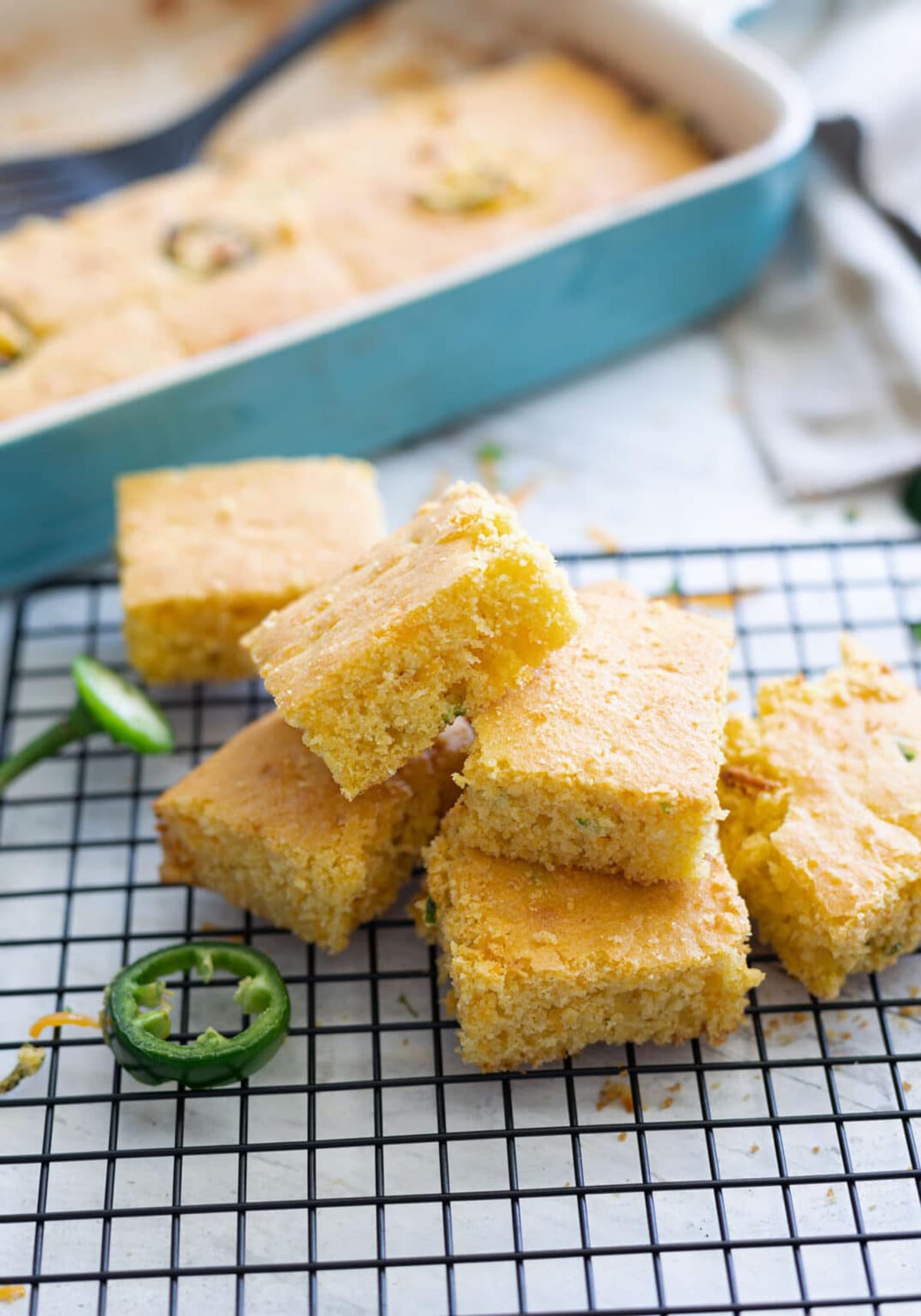 Six pieces of cornbread cut and cooling on a cutting tray.