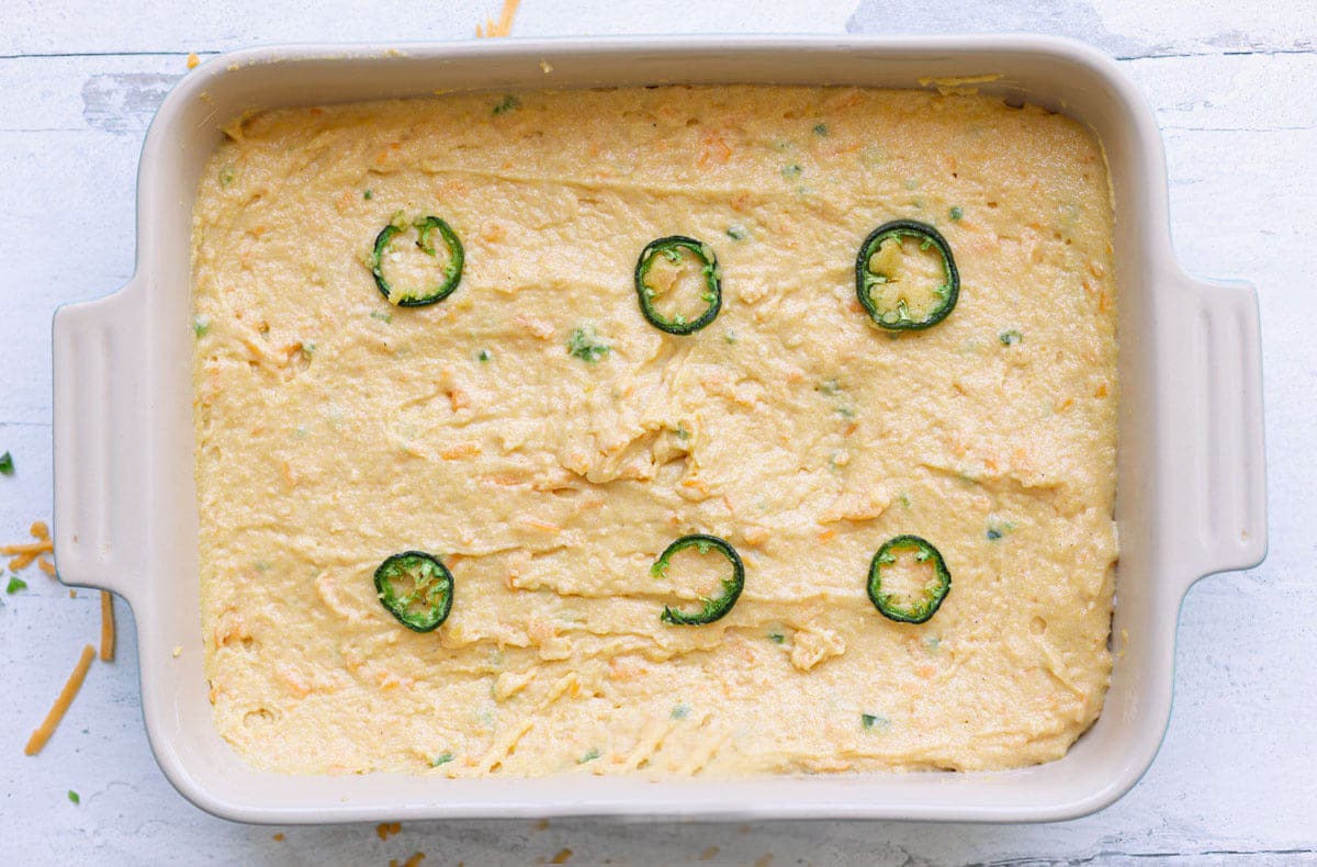 Baking dish filled with cornbread mix getting ready to be baked. 