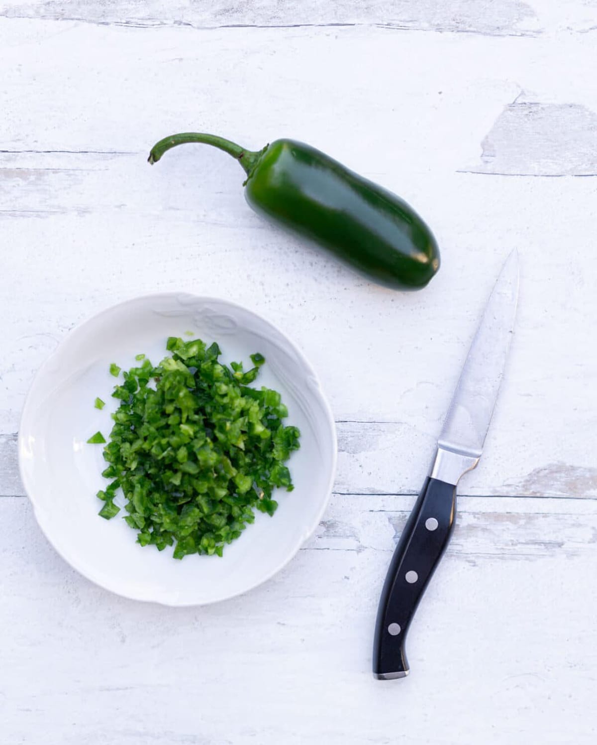Diced jalepano pepper in a dish.