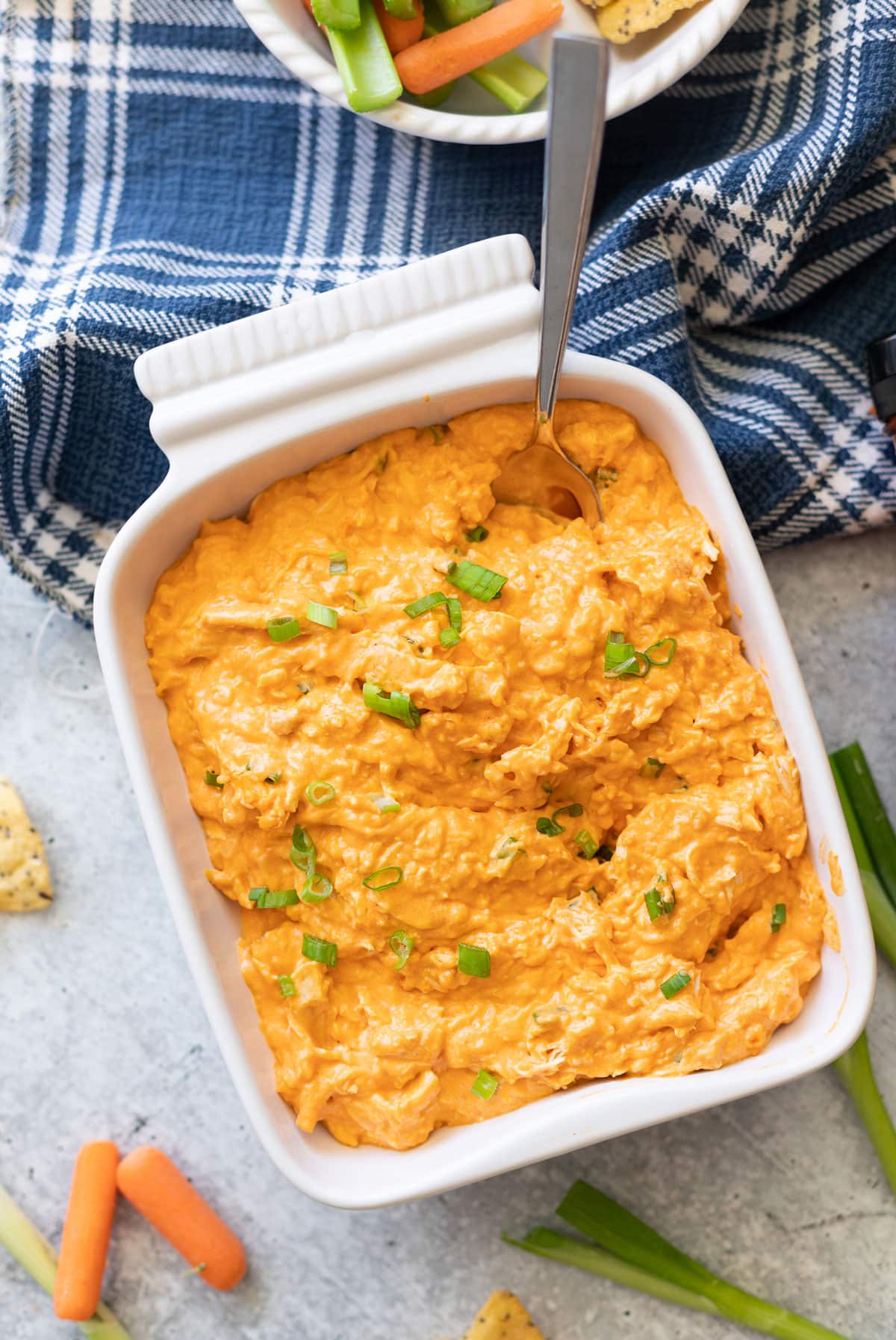 Dish containing buffalo chicken dip being served.