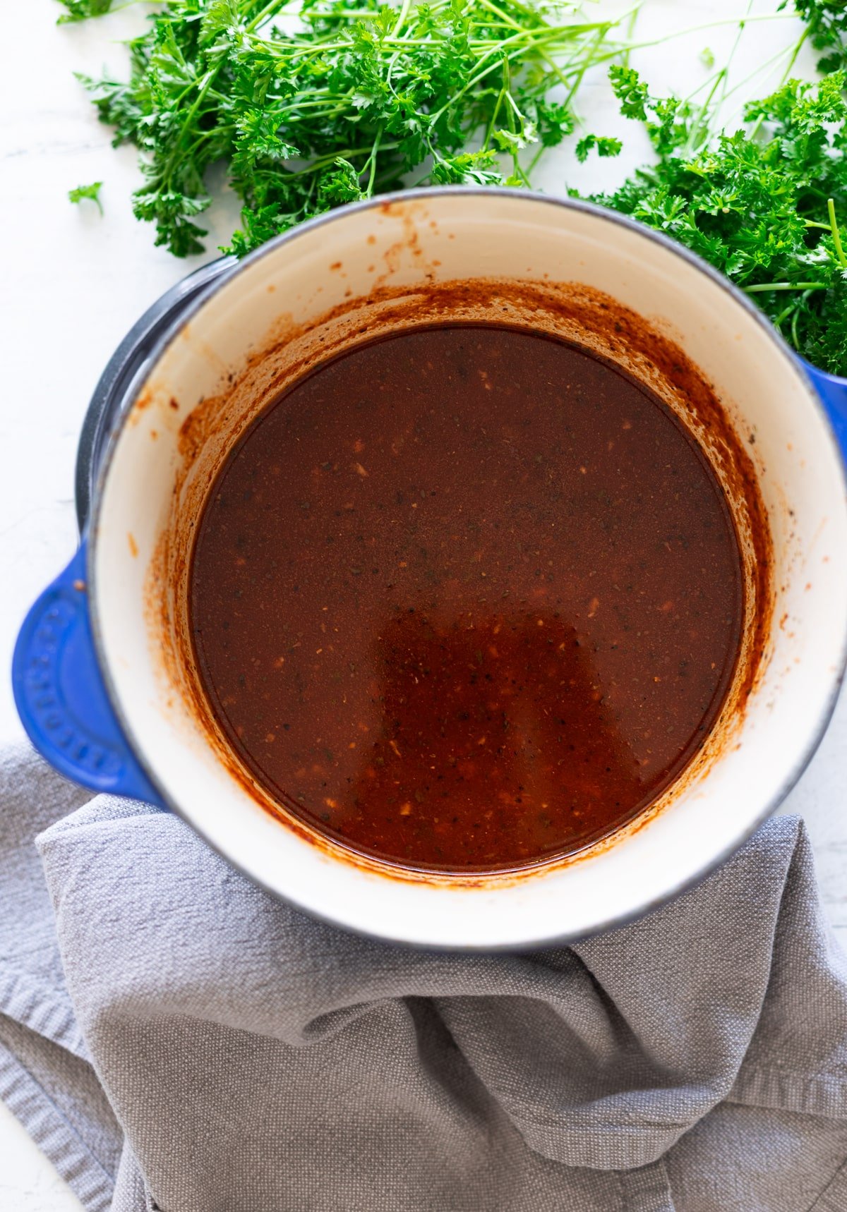 Red enchilada sauce in a pot on the stove. 