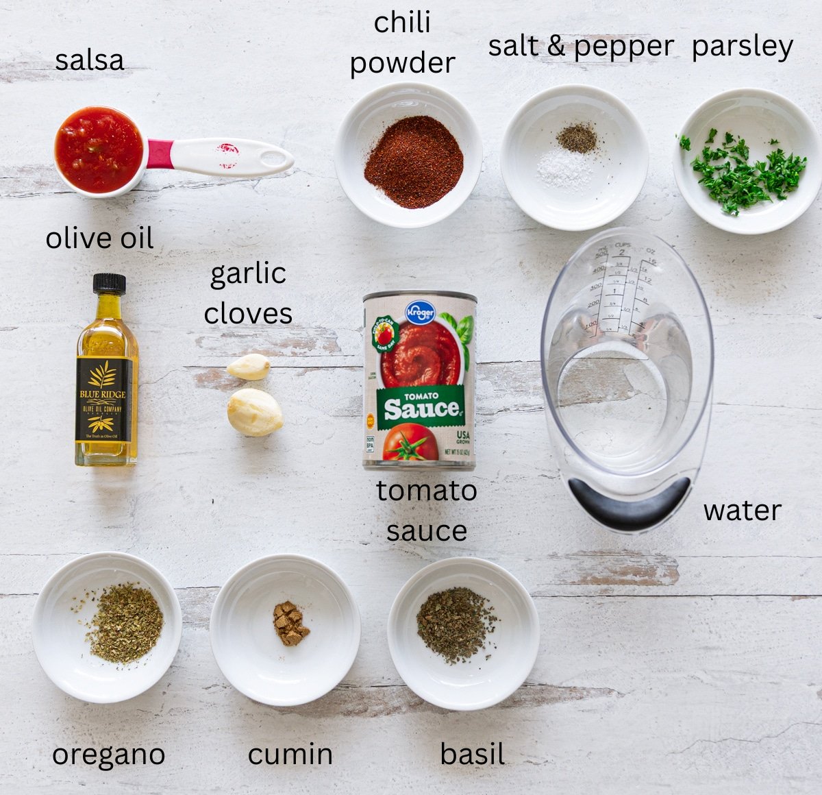 Ingredients on a kitchen counter to make a homemade red enchilada sauce. 