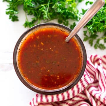 Bowl of homemade red enchilada sauce on a counter.