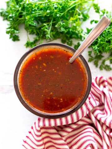 Bowl of homemade red enchilada sauce on a counter.