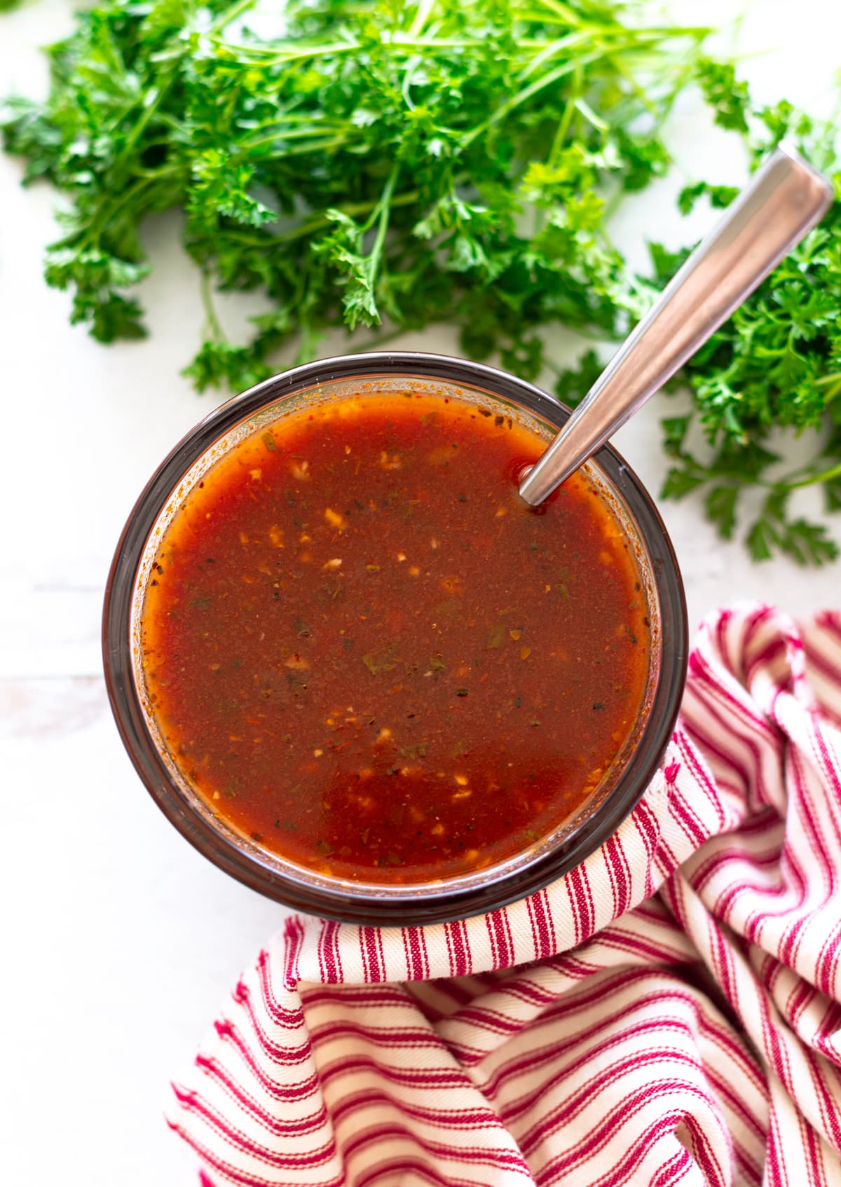 Glass bowl filled with enchilada sauce.