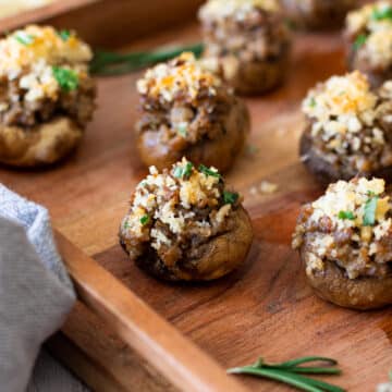 Close up of a mushroom stuffed with sausage and cheese.