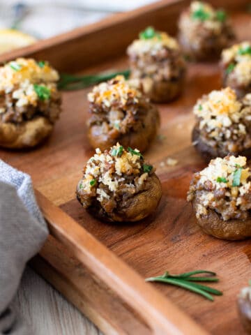 Close up of a mushroom stuffed with sausage and cheese.