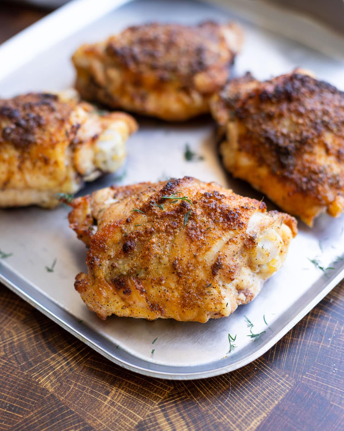 Close up of crispy chicken thighs on a platter