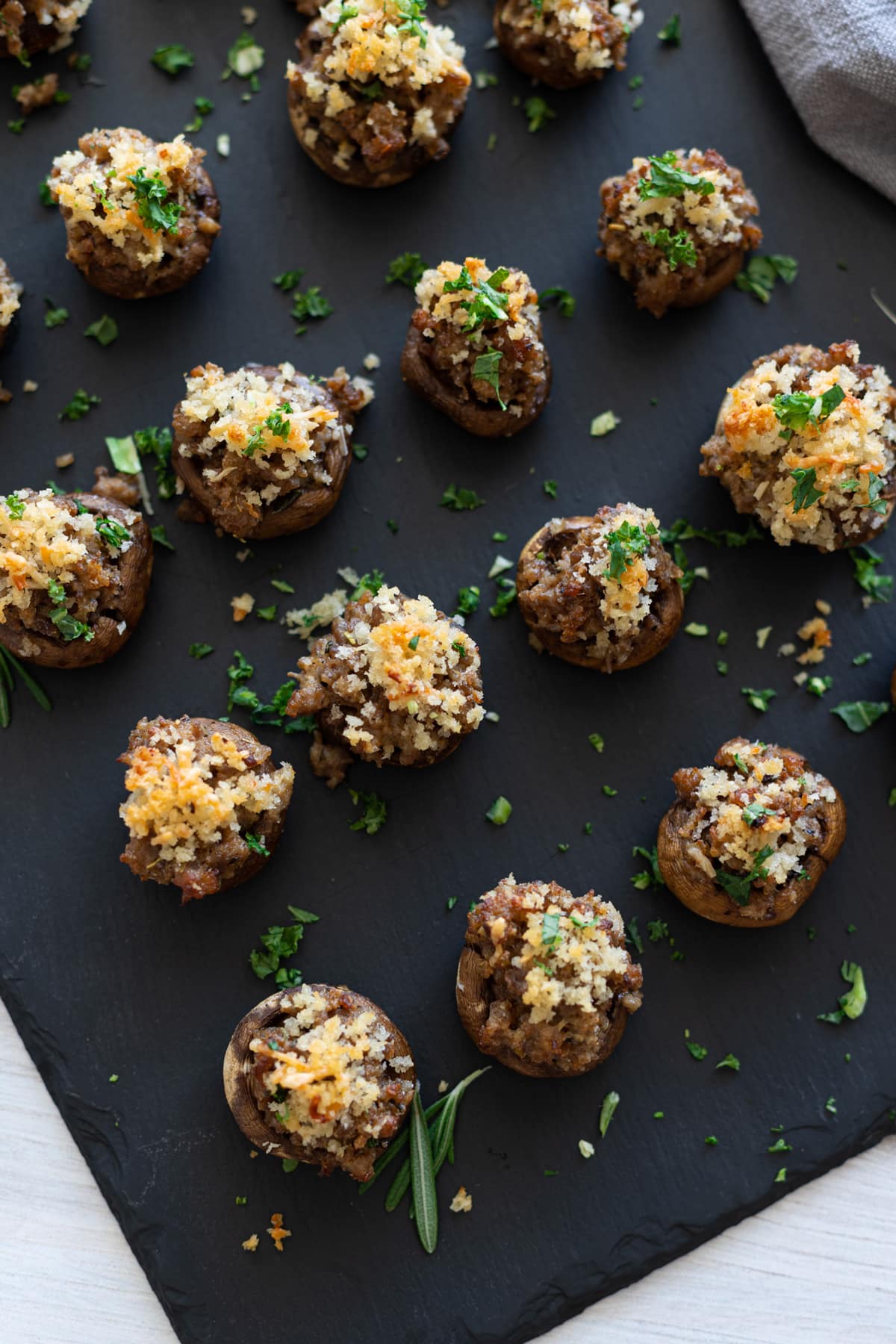 Serving dish filled with sausage stuffed mushrooms. 