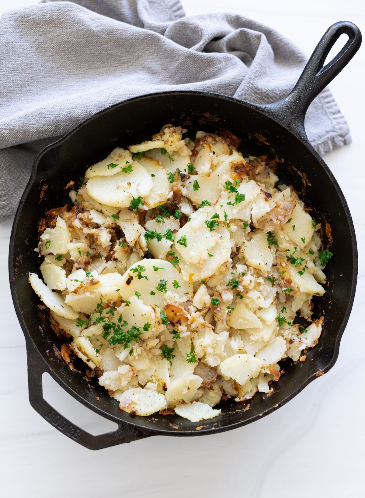 Cast iron skillet with freshly cooked potatoes.