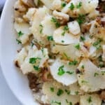 Plate filled with skillet fried potatoes.