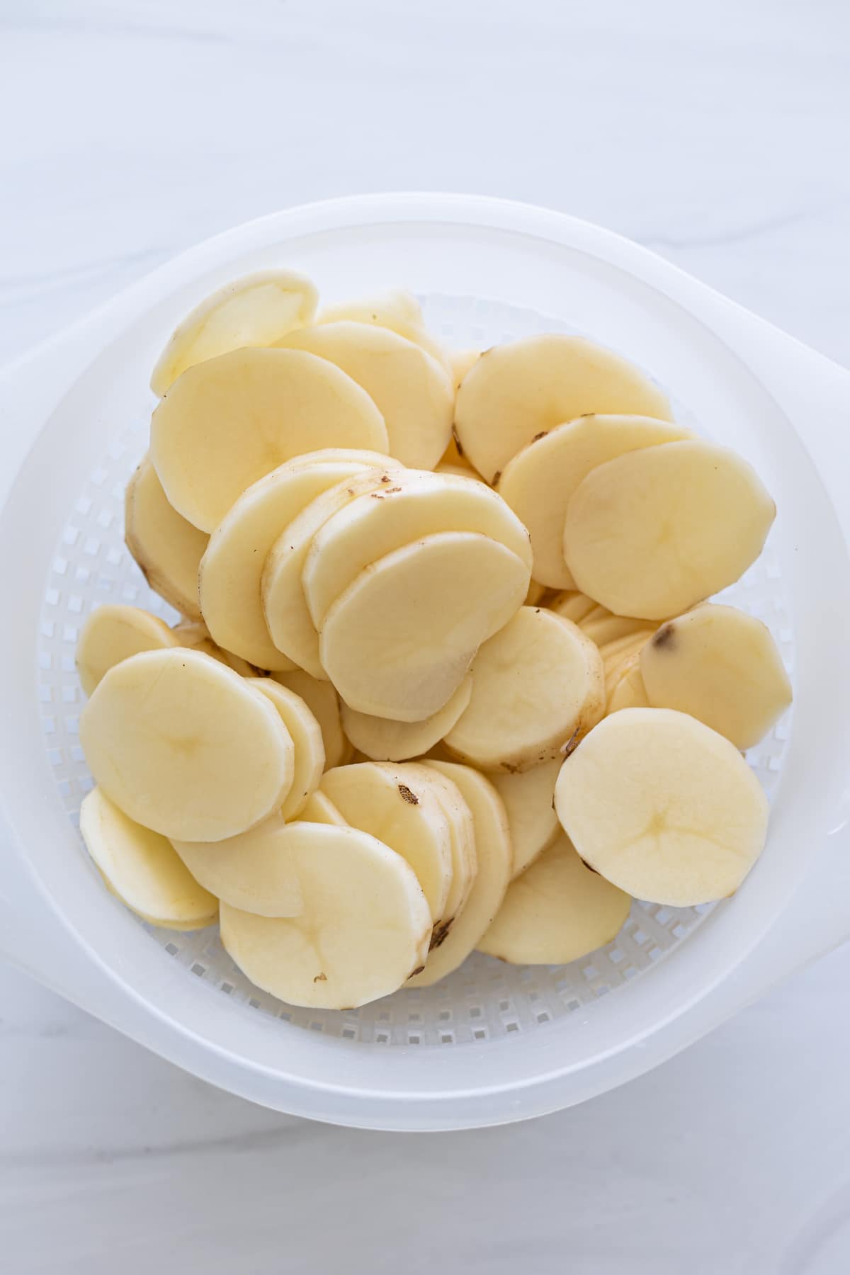 Potatoes being drained in a colander.
