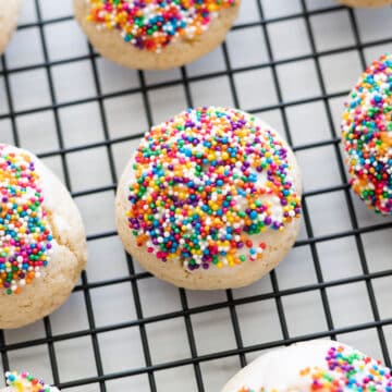 Anise cookie cooling on a wire rack topped with sprinkles.