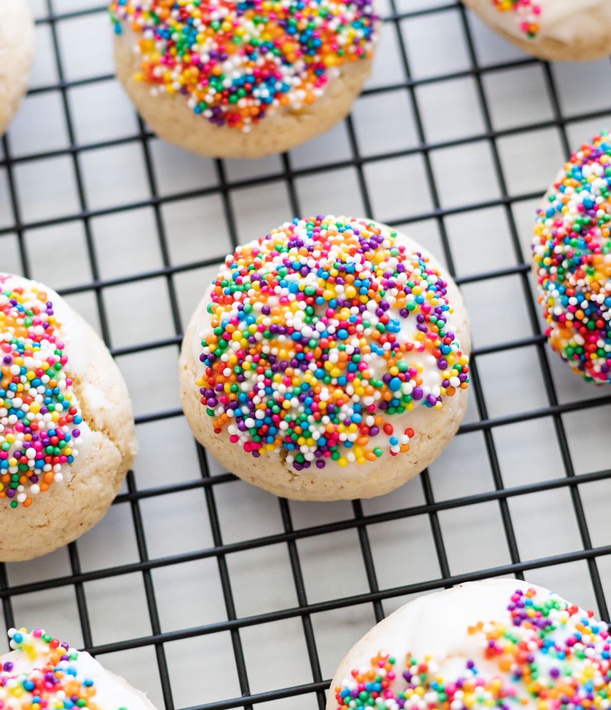 Close up of an anise cookie on a wire rack. 
