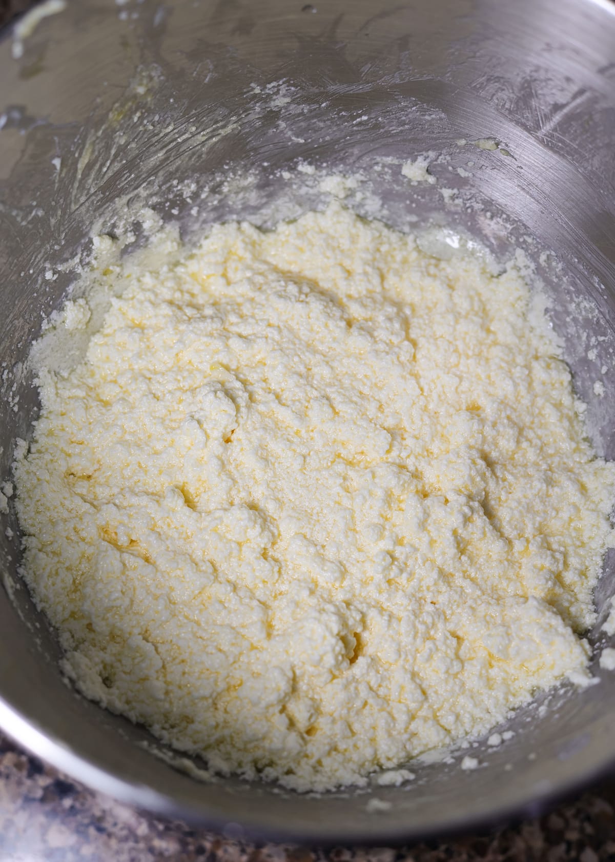 Cookie batter curdled in a bowl. 