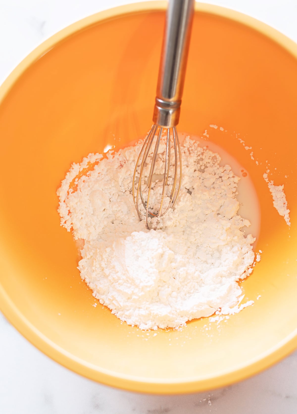 Person making anise glaze in a bowl. 