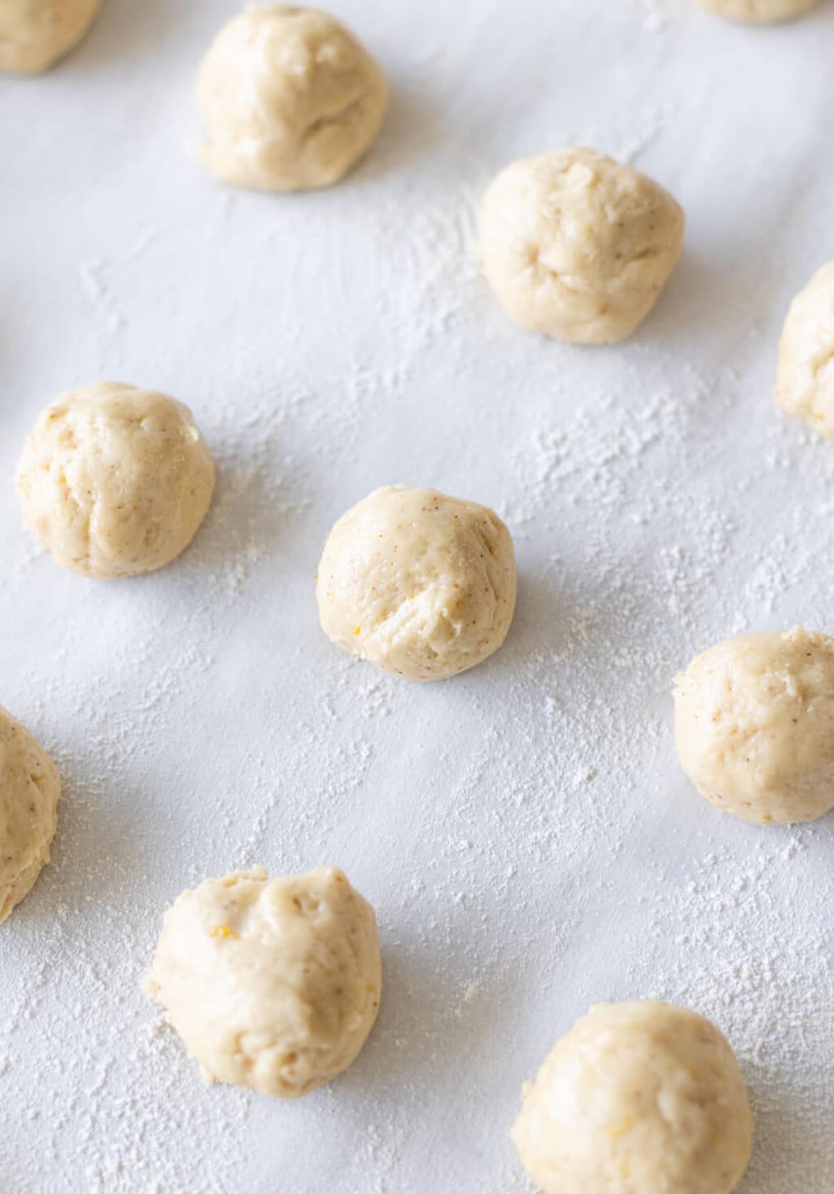 Rolled anise cookies on a cookie sheet ready for baking. 