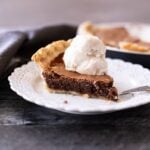 Slice of a piece of chocolate pie on a plate.