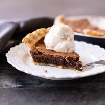 Slice of a piece of chocolate pie on a plate.