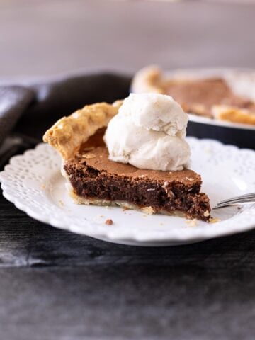 Slice of a piece of chocolate pie on a plate.