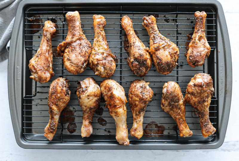 Chicken legs backing on a wire rack.