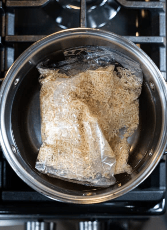 Boil in a bag rice cooking in a pot on the stove top.
