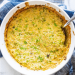 Corning ware filled with broccoli and cheese casserole.