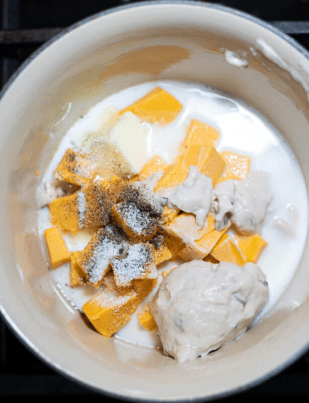 Pot filled with melted cheese, milk, and cream of mushroom soup.