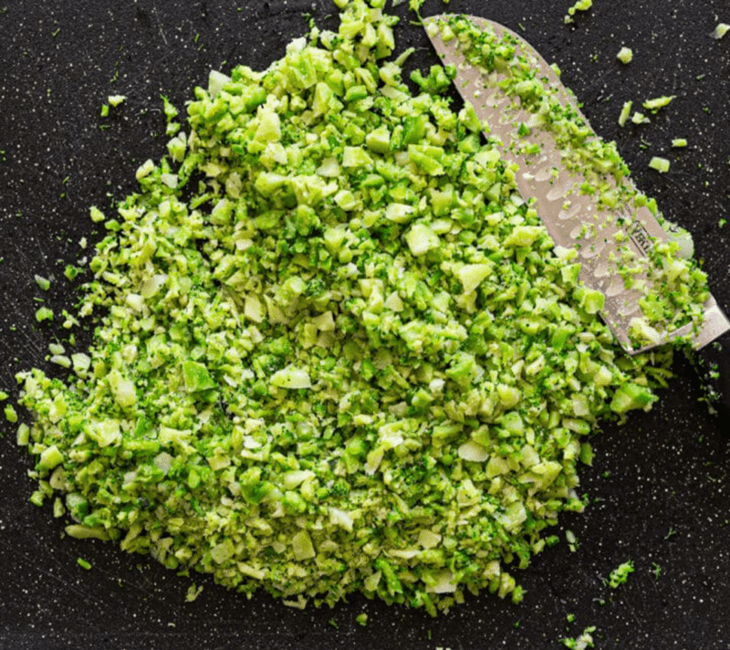 Chopped broccoli on a counter.