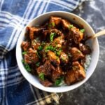 Bowl filled with steak bites over rice.