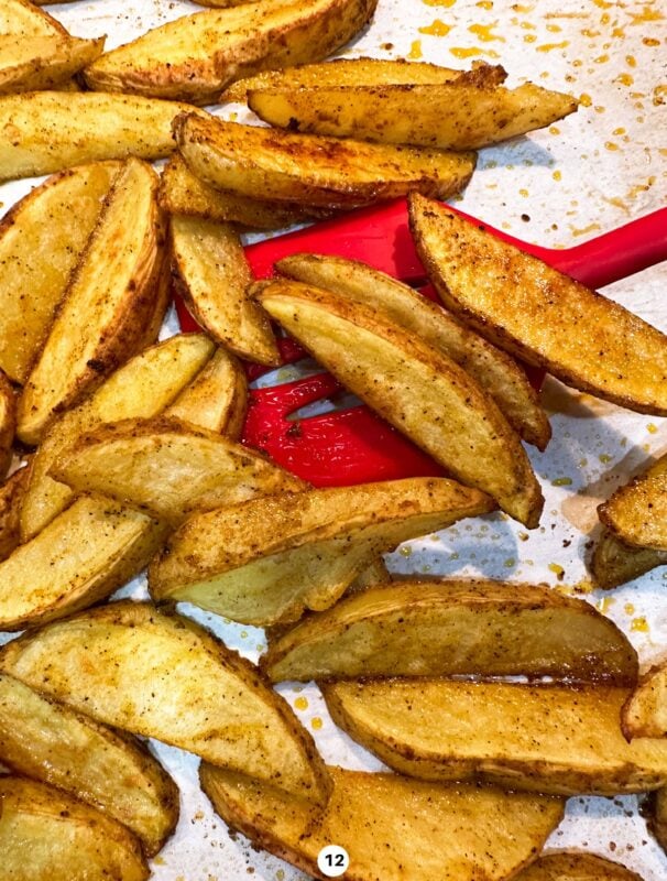 Person serving oven baked french fries.