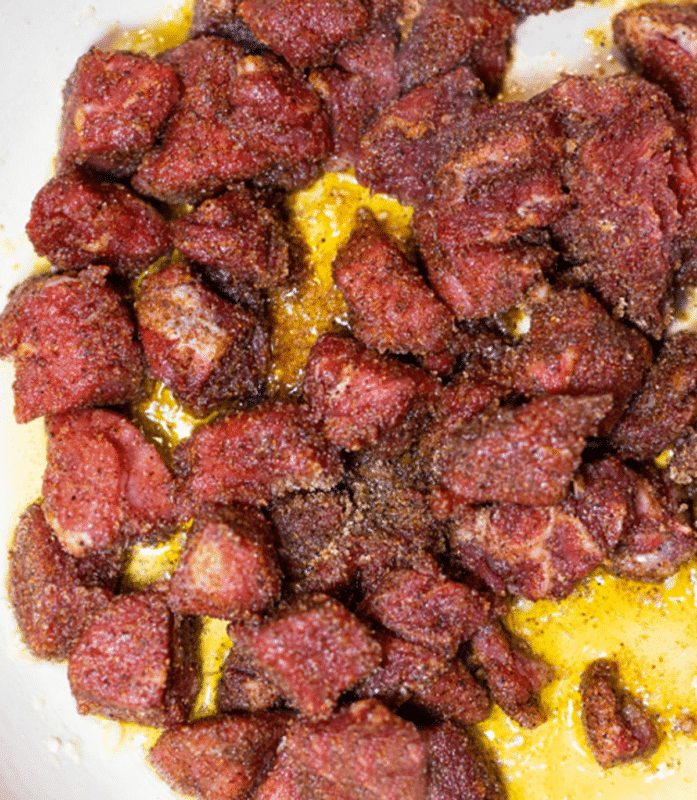 Searing steak bites in a skillet.