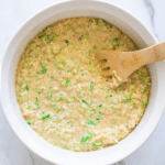 Uncooked broccoli and rice casserole in a baking dish.