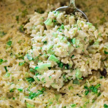 Person serving a spoonful of broccoli rice casserole from a dish.