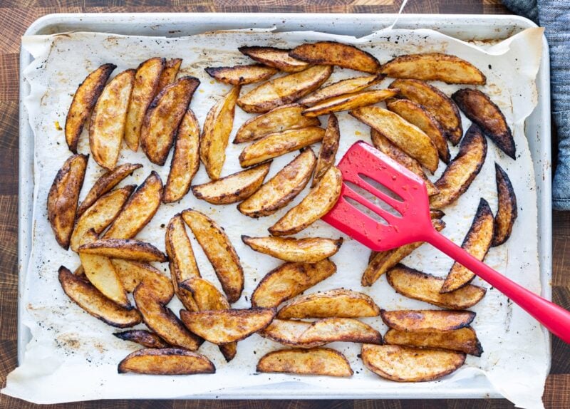 Large baking dish filled with cooked steak fries.