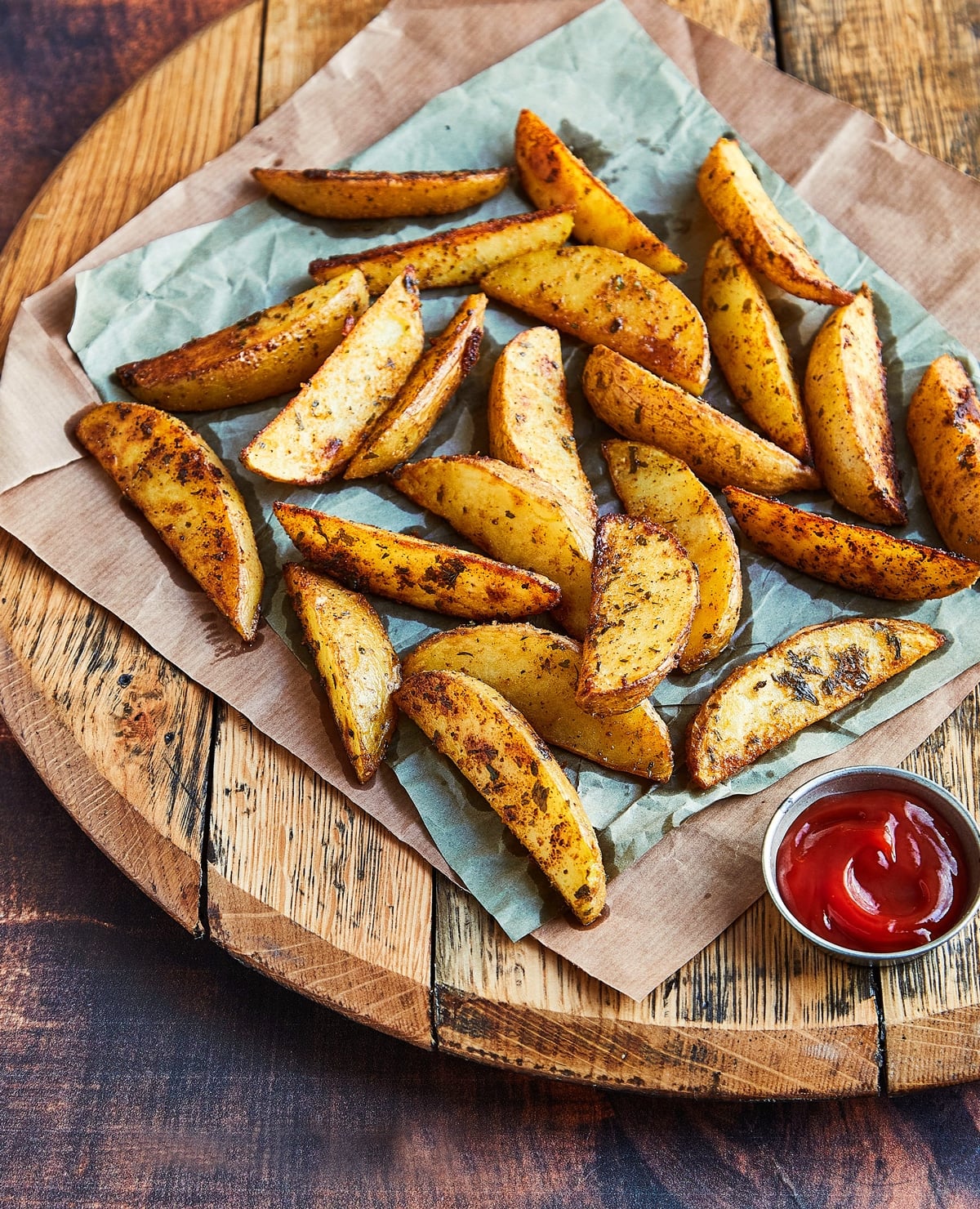 Steak French fries on a serving dish with ketchup.