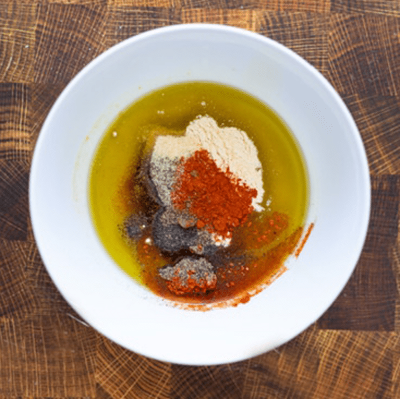 Bowl filled with steak fry seasoning.